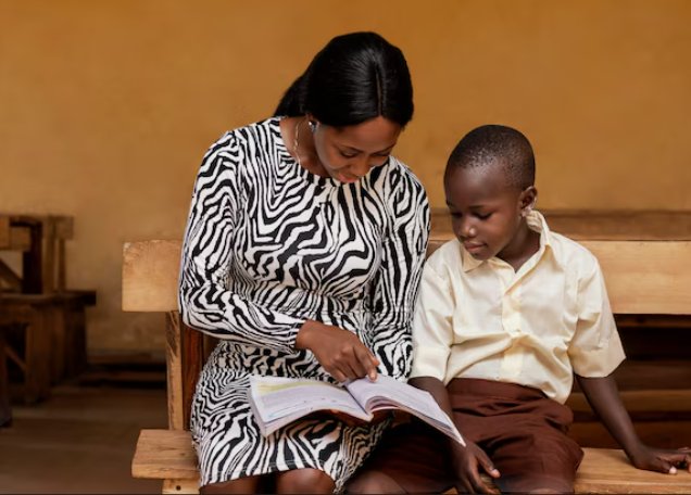 A mentor and a young learner reading together